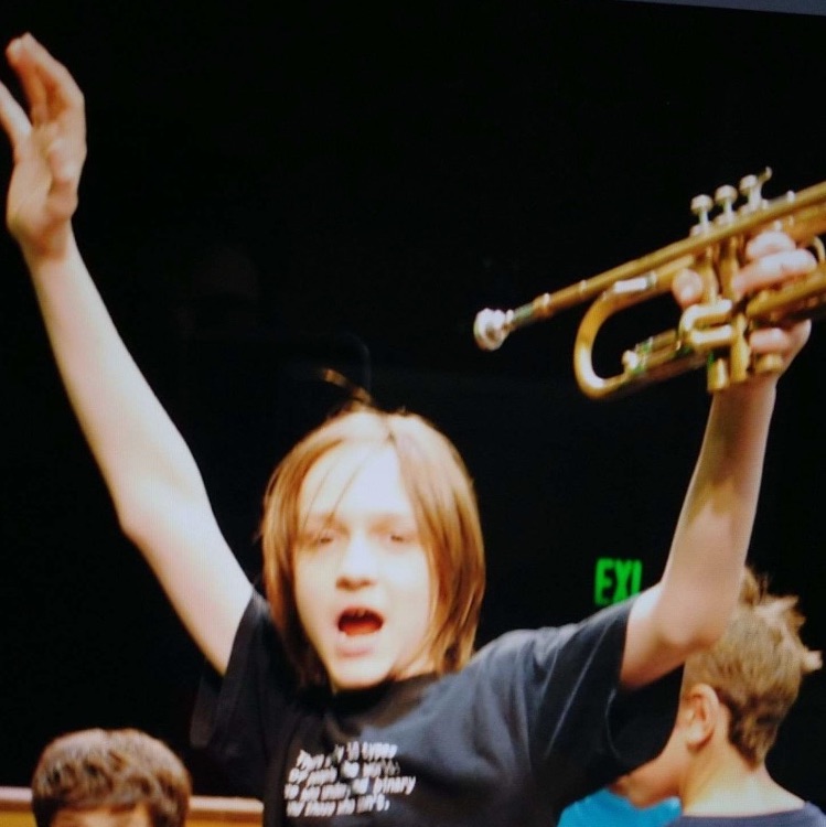 Middle school me, trumpet in hand, wearing a 10-types-of-people shirt